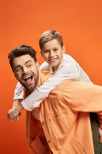 A father and son share joyful moments, making cherished memories in a festive setting. — Stock Photo