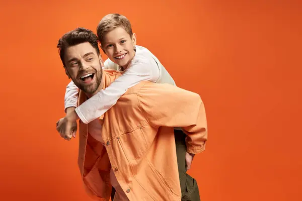 A father and son share a joyful moment, embracing together on a special day. — Stock Photo