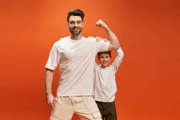 A father and son share a joyful moment, displaying strength and love on Fathers Day 2025. — Stock Photo