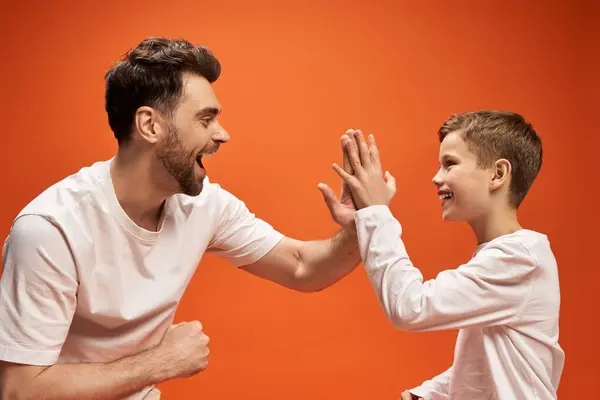 A joyful father and son enjoying playful moments together, celebrating their bond. — Stock Photo