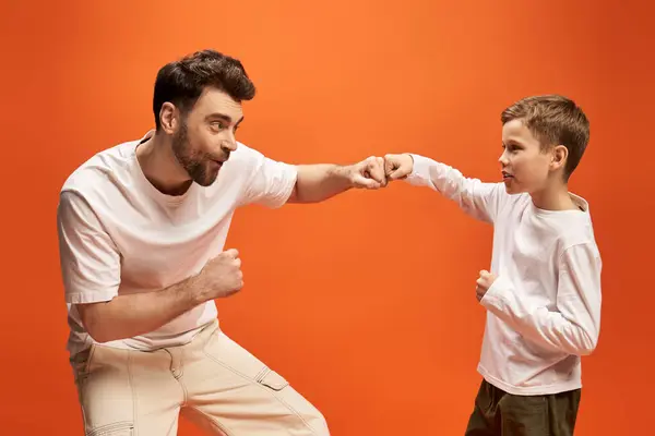 Father and son joyfully enjoy a playful fist bump, celebrating togetherness on Fathers Day. — Stock Photo