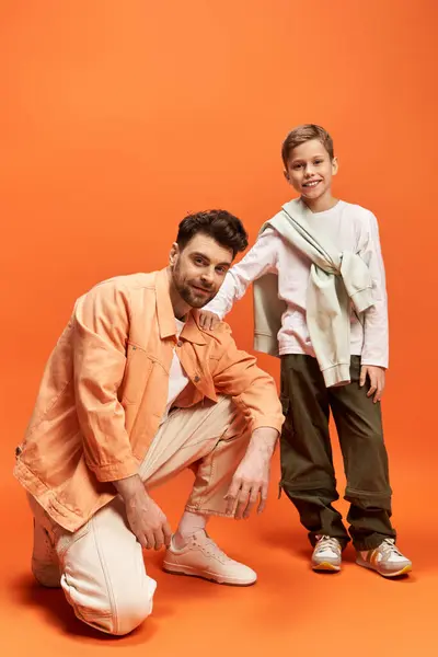 A joyful father and son pose together in a vibrant setting, embracing their bond on Fathers Day. — Stock Photo