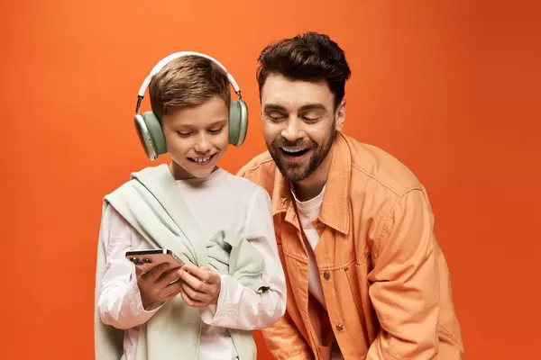 Father and son share a joyful connection while enjoying music during a festive celebration. — Stock Photo