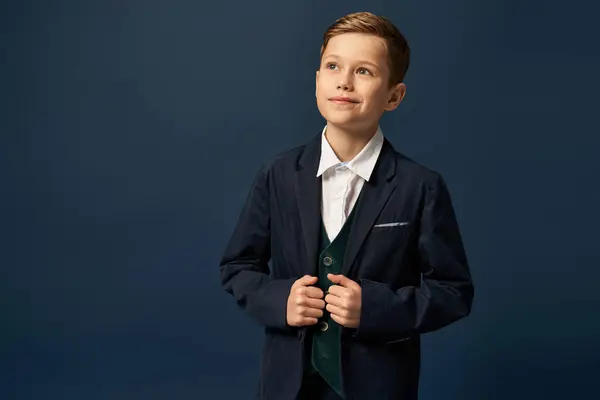 A cheerful boy in formal attire radiates joy while posing on dark backdrop. — Stock Photo