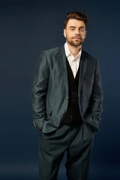Confident man dressed elegantly, embracing the joy on dark backdrop. — Stock Photo