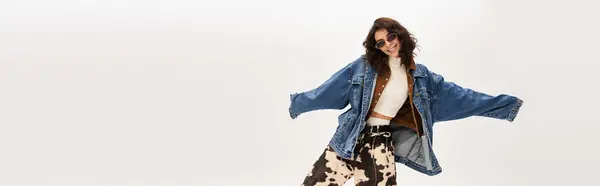 Stylish young woman poses confidently in a trendy outfit featuring cow print pants, banner — Stock Photo