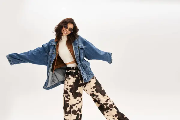 A young woman poses confidently in a trendy cow print outfit, bringing fashion to life. — Stock Photo