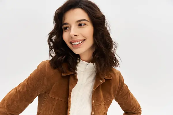 Young woman in fashionable cow print pants and stylish top stands against a grey backdrop. — Stock Photo
