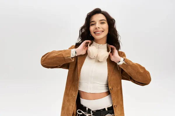 A young woman showcases her fashion sense with stylish jacket, smiling. — Stock Photo