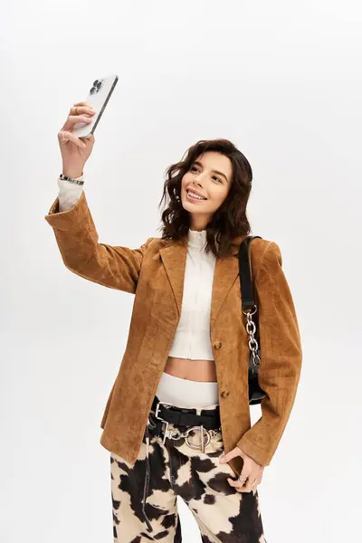A young woman takes a confident selfie in trendy cow print pants. — Stock Photo