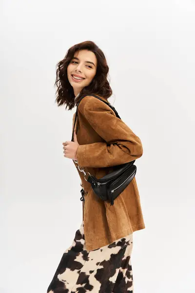 A young woman flaunts her fashion sense in cow print pants and a chic brown blazer. — Stock Photo
