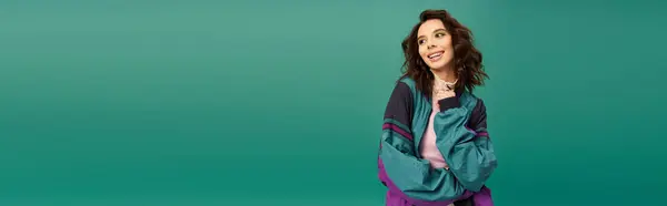 A confident young woman poses in a stylish sporty outfit against a bright turquoise backdrop, banner — Stock Photo