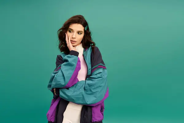 A fashionable young woman showcases her sporty style with confidence in a studio. — Stock Photo