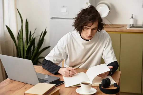 A young man studies at home, relaxed in comfy clothes, in a calm environment. — Stock Photo