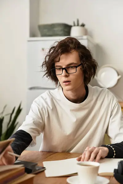 In a cozy setting, a young man engages in creative activities, lost in thought and concentration. — Stock Photo