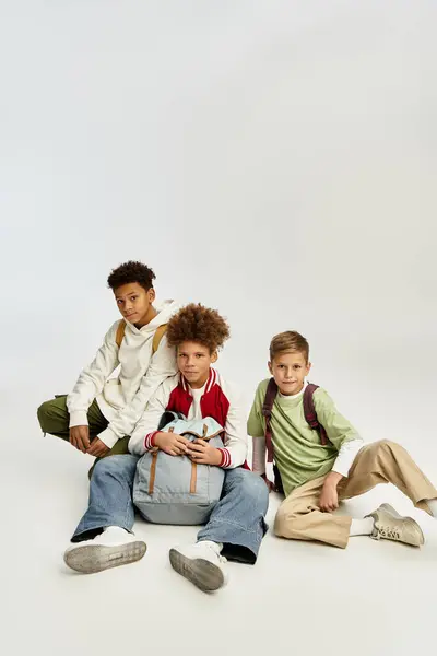 Three adorable boys dressed in vibrant outfits share a joyful moment, showcasing their friendship. — Stock Photo