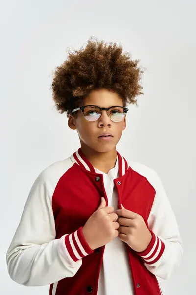 Adorable child showcases trendy fashion with colorful jacket and glasses, exuding confident charm. — Stock Photo