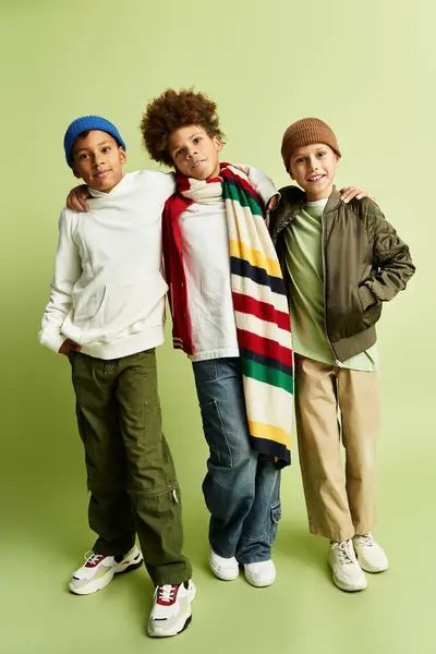 Three adorable little boys showcase their stylish outfits while enjoying a close friendship. — Stock Photo