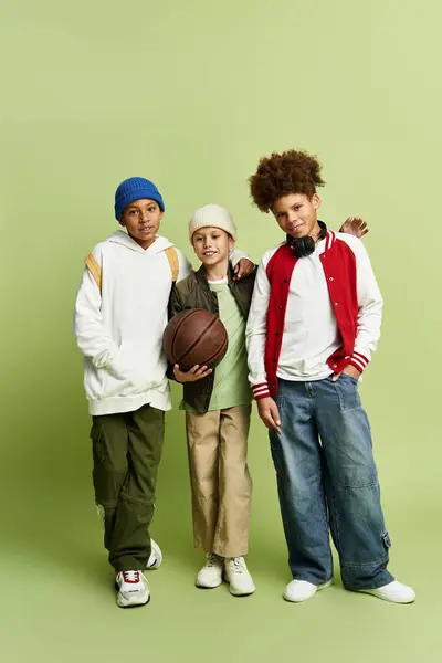 Three stylish boys hold a basketball, radiating joy together. — Stock Photo