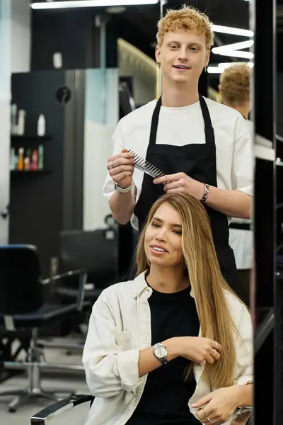A talented stylist works on a clients hair, showcasing the latest trends in a modern beauty salon. — Stock Photo