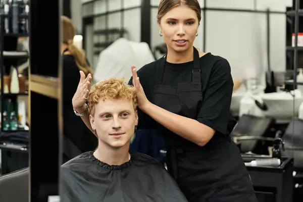 Stylists discuss the latest techniques while transforming a clients hair in a modern beauty salon. — Stock Photo