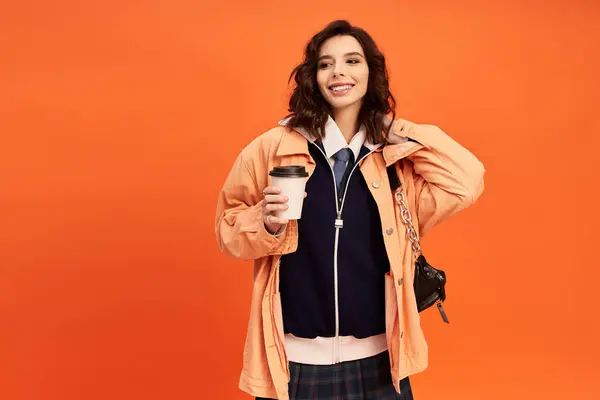 Young woman showcases her fashionable attire, exuding charm and confidence in a bright studio. — Stock Photo