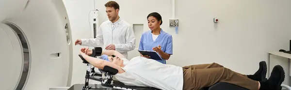 Healthcare professionals assist a female patient for an MRI scan in a contemporary medical facility, banner — Stock Photo