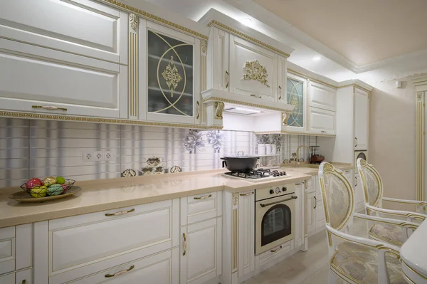 Interior renovation showcase of rich classic white kitchen, drawers retracted