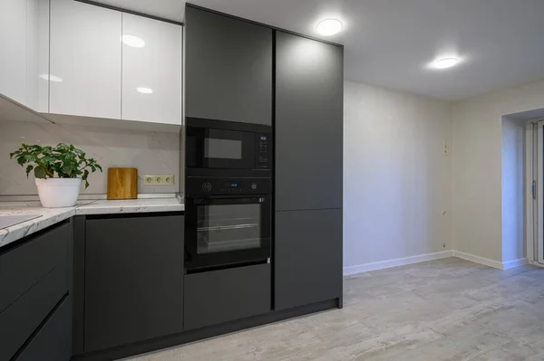 Showcase interior of modern simple trendy dark grey and white kitchen