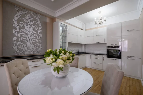 stock image Luxury white modern kitchen with round dining table in studio apartment