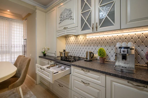 Beige spacious kitchen with a classic aesthetic and modern conveniences