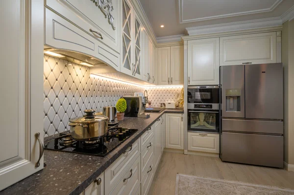 stock image Elegant, open-concept kitchen with a beige color scheme and classic design elements, closeup to worktop