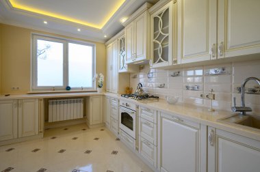 Dairenin içinde klasik beyaz ve bej renkli lüks mutfak.