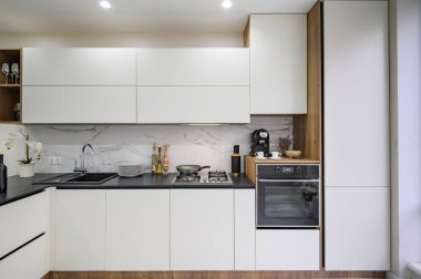 Large white and black luxury kitchen interior, front view