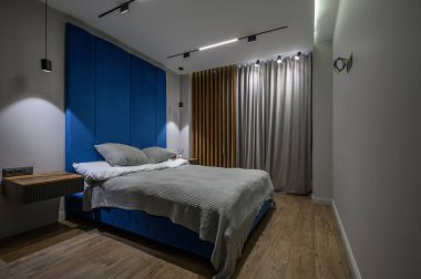 Cozy and luxury master bedroom in blue and gray colors with elegant and modern details