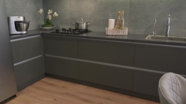 Modern trendy luxury dark grey kitchen closeup to work top, tiilt shot