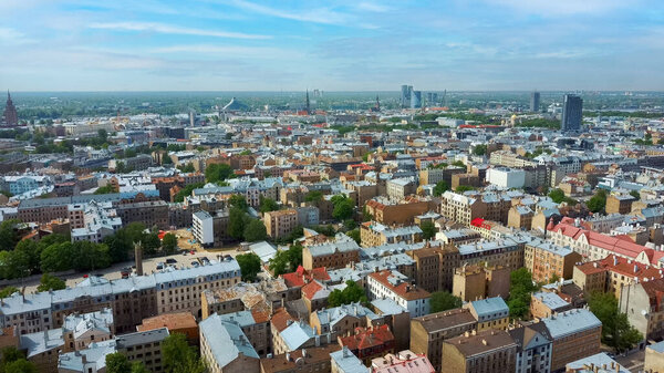 Riga Cityscape Spring Aerial Top View Video, Town, Latvia. Sunny Day Building Rooftops. Riga Skyline, Latvia, City Center, Teika, Purvciems in the Background. Architecture of the Downtown.
