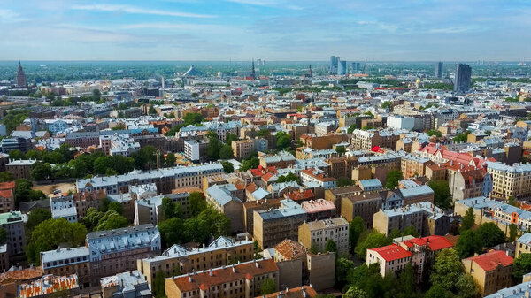 Riga Cityscape Spring Aerial Top View Video, Town, Latvia. Sunny Day Building Rooftops. Riga Skyline, Latvia, City Center, Teika, Purvciems in the Background. Architecture of the Downtown.