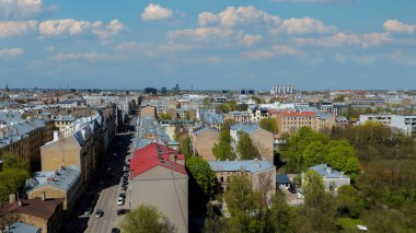 Aerial Drone View Of Riga Panorama In Latvia On A Sunny Spring Day Showcasing The Rooftops Of Houses The Vibrant City Center Historic Buildings And Barona Street Playground of the Downtown Sports Area