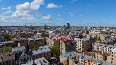 Aerial Drone View Of Riga Panorama In Latvia On A Sunny Spring Day Showcasing The Rooftops Of Houses The Vibrant City Center Historic Buildings And Barona Street Playground of the Downtown Sports Area