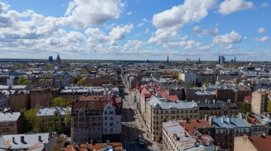 Aerial Drone View Of Riga Panorama In Latvia On A Sunny Spring Day Showcasing The Rooftops Of Houses The Vibrant City Center Historic Buildings And Barona Street Playground of the Downtown Sports Area