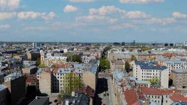 Aerial Drone View Of Riga Panorama In Latvia On A Sunny Spring Day Showcasing The Rooftops Of Houses The Vibrant City Center Historic Buildings And Barona Street Playground of the Downtown Sports Area