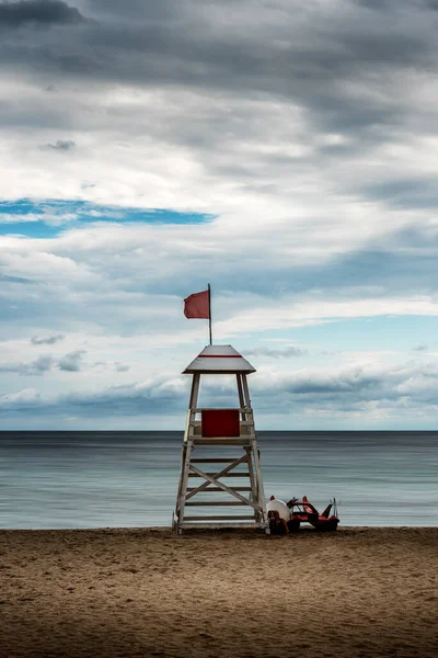 stock image Sea sandy beach and white wooden watchtower (rescue post)