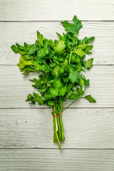 Fresh parsley on a white wooden table