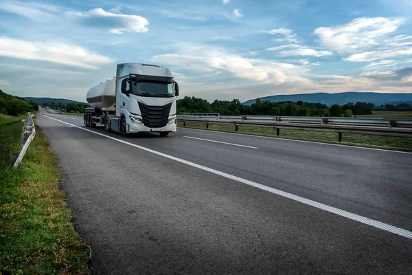 Tanker or Tank Truck on a highway road under blue sunrise sky