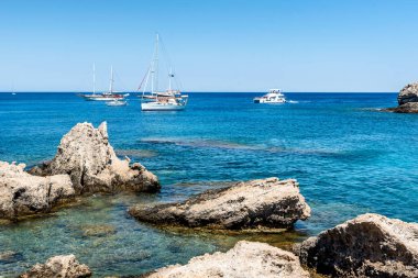 Yachts on beautiful Kallithea beach, Rhodes Island clipart