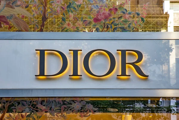 stock image ZURICH, SWITZERLAND - AUGUST 3, 2022: Close up of Dior store projecting sign on the building. Christian Dior SE, commonly known as Dior, is a French luxury fashion house.