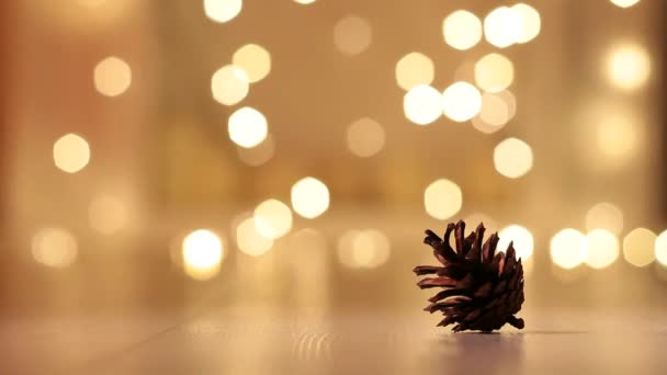 在圣诞灯火的背景上戴着针织帽子的锥形松木 带针织帽子的锥形松木 背景为圣诞灯火 — 图库视频影像