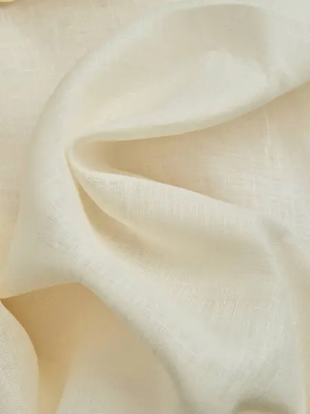 Güzel bej kumaş kıvrımları. Bej kumaşın yüksek kaliteli dokusu.