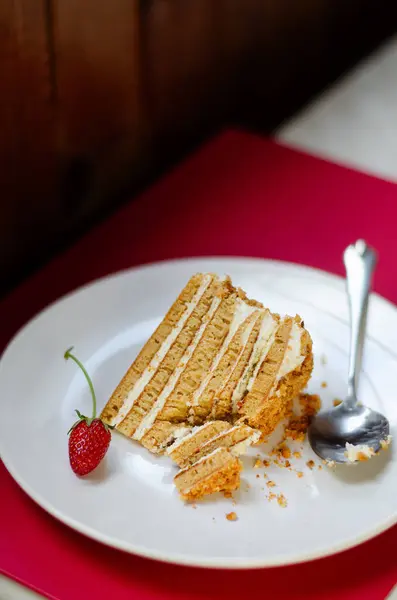 stock image Slice Crepe cake Medovik with sour cream vanilla cream and strawberries. Slice Pancake cake Medovik decorated with strawberries.